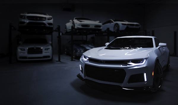 Camaro with LED headlights in a showroom garage